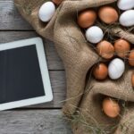 Fresh chicken eggs on sack and tablet, internet order concept